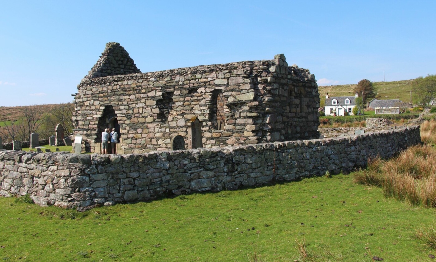Kilmory Knap Chapel, at the end of the Knapdale road, roofed in glass to shelter the cross and the carved West Highland slabs inside. Photograph © Alan Reid, CC